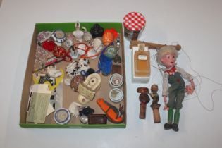 A box containing Pelham puppet; bottle stoppers; c