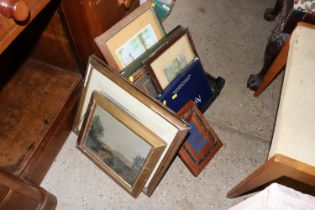 A plastic crate of various pictures and prints