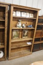 A pine open fronted bookcase with four adjustable