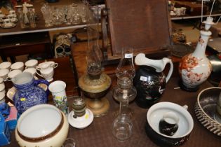 Three oil lamps with glass chimneys