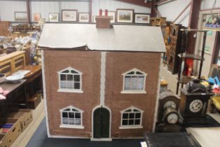 A large dolls house and three boxes of various dol