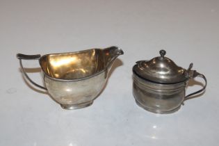 A silver cream jug and a silver mustard, approx. t