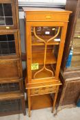 A reproduction yew wood glazed cabinet, fitted two