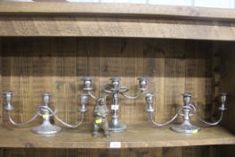 Three silver plated candelabras and a brass bear