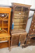 A walnut veneered bookcase, fitted cupboard below