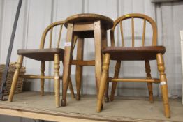 A pair of child's stick back chairs and a circular