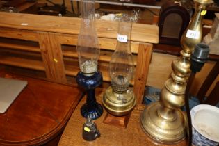 A blue glass oil lamp with glass chimney; a brass