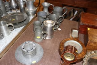 A quantity of antique and later pewter tankards and an inkwell