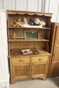 A pine dresser fitted two drawers over cupboard ba