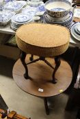 An oak and oval topped side table raised on tripod