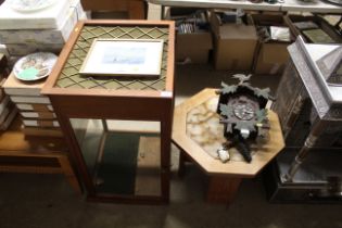 A display cabinet and a tile topped coffee table