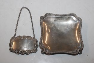 A silver dish raised on four paw supports; and a s