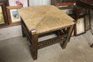 A hard wooden rush covered coffee table