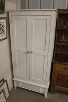 A white painted pine two door wardrobe fitted sing