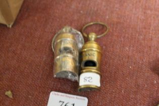 Two reproduction brass whistles (82)