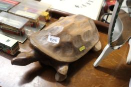 A carved wooden tortoise