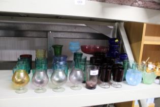 A collection of coloured glass ware including cran