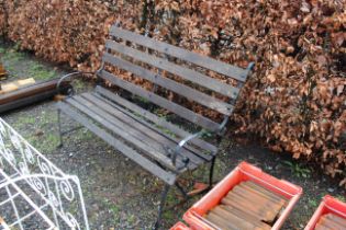 A wooden slatted metal framed garden bench with sc