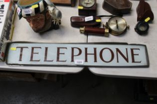 A glass telephone sign