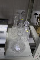 Four glass decanters, one lacking stopper