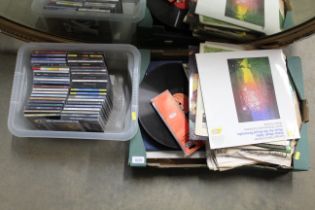 A box of various LPs and CDs