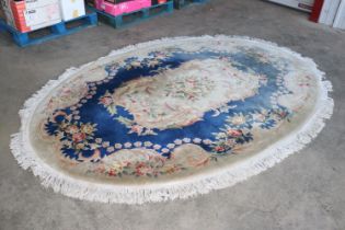 An approx. 9'8" x 6'11" oval patterned rug AF