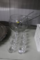 A glass punch bowl, ladle and cups