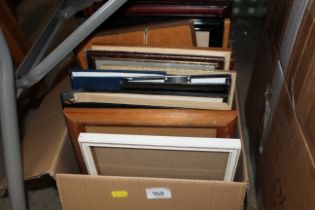 A box of pictures frames and photo albums