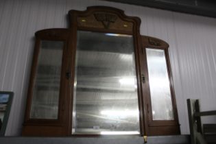 A carved oak and walnut veneered triptych mirror