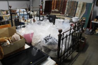 An antique brass and iron double bed