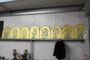 Eight gilt arch framed botanical studies