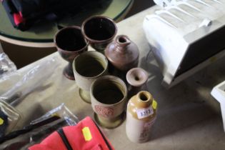 A quantity of various stoneware cups AF