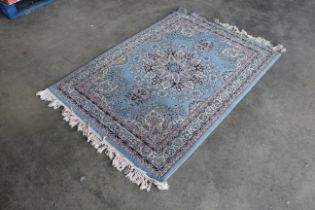 An approx. 6' x 4' blue patterned rug AF