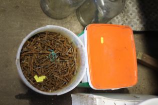 A tub of natural fertiliser and a bucket of nails,