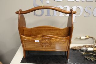 An Oriental hardwood magazine rack