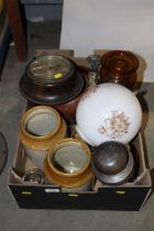 A box containing glass decanters, ornaments, stone