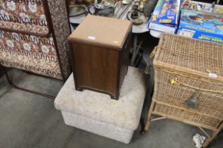 An upholstered footstool and storage stool