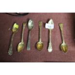 Five continental gilt white metal spoons and one other white metal spoon