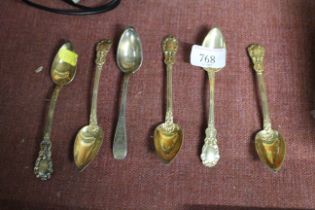 Five continental gilt white metal spoons and one other white metal spoon