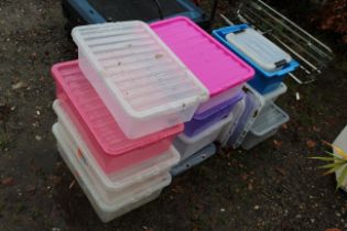 A quantity of plastic stacking storage boxes