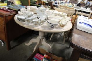 A circular table and set of three stick back chair