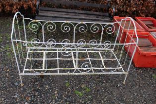 A white wrought metal child's bed