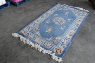 An approx. 7'6 x 4'2" blue patterned rug AF