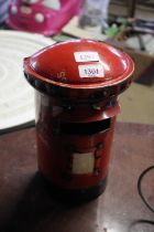 A recycled tin model in the form of a post-box/bir