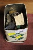 A tin containing padlocks and keys