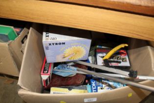 A box of various sundries including VHS tapes