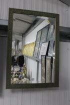 A framed bevel edged wall mirror