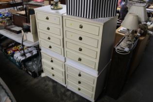 A pair of bedside chests fitted three drawers and