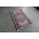 An approx. 5'6" x 3' patterned rug
