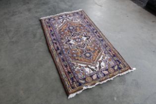 An approx. 5'6" x 3' patterned rug